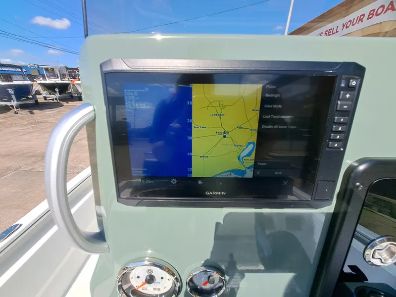 Slide: The Image of A modern navigation system on a boat with a Garmin screen and control instruments. - 34