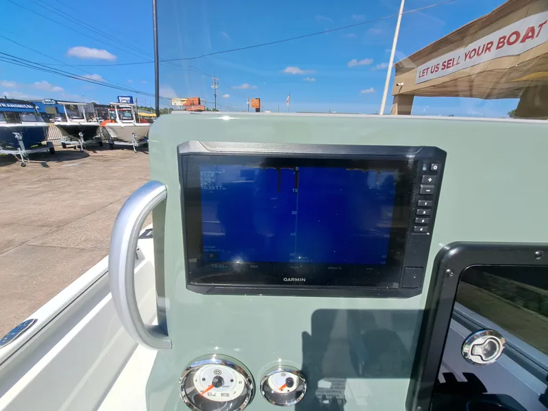 Slide: The Image of The image shows a modern boat cockpit with a Garmin screen and instruments. - 32