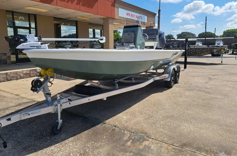 Slide: The Image of An Avid 21MAG ST boat from 2027 is on a trailer outside a store. - 3
