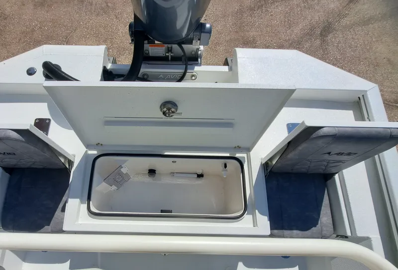 Slide: The Image of The image shows the stern of an Avid 21MAG ST boat with an open storage compartment. - 25