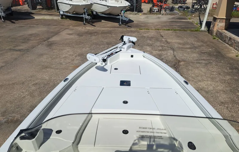 Slide: The Image of The image shows the deck of a 2027 Avid 21MAG ST boat with a trolling motor. - 15