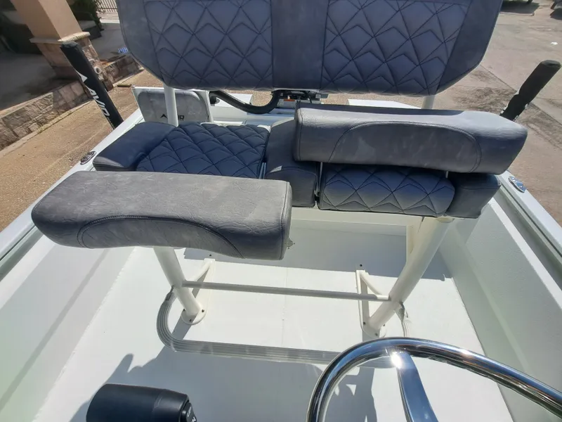 Slide: The Image of The image shows the seating area of a 2027 Avid 21MAG ST boat with padded blue seats. - 26