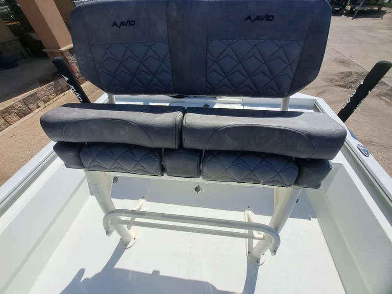 Slide: The Image of The 2027 Avid 21MAG ST features a cushioned bench seat with blue upholstery and a quilted pattern. - 27