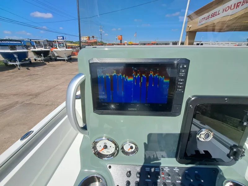 Slide: The Image of The image shows the dashboard of an Avid 21MAG ST boat with a Garmin screen. - 33
