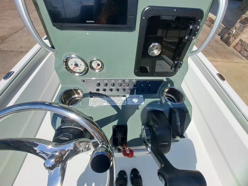 Slide: The Image of The image shows the helm of an Avid 21MAG ST boat with modern instruments and controls. - 30