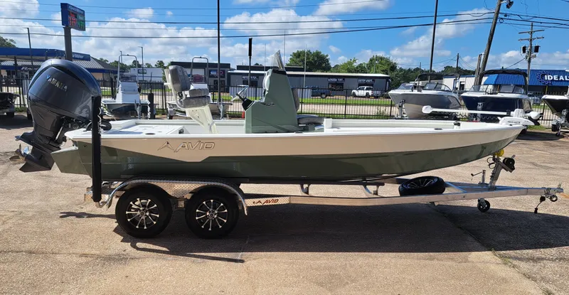 Slide: The Image of A 2027 Avid 21MAG ST boat on a trailer, featuring an outboard motor and clear skies in the background. - 8