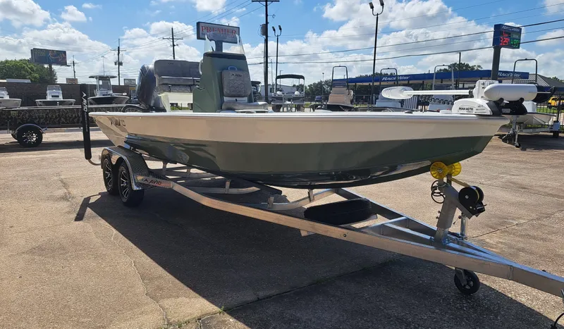 Slide: The Image of An Avid 21MAG ST boat from 2027 sits on a trailer in a parking lot under blue skies. - 7