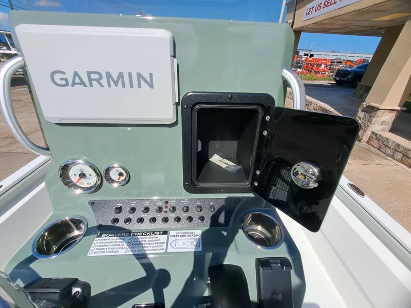 Slide: The Image of The image shows a boat dashboard with Garmin navigation, instruments, and an open storage compartment. - 28