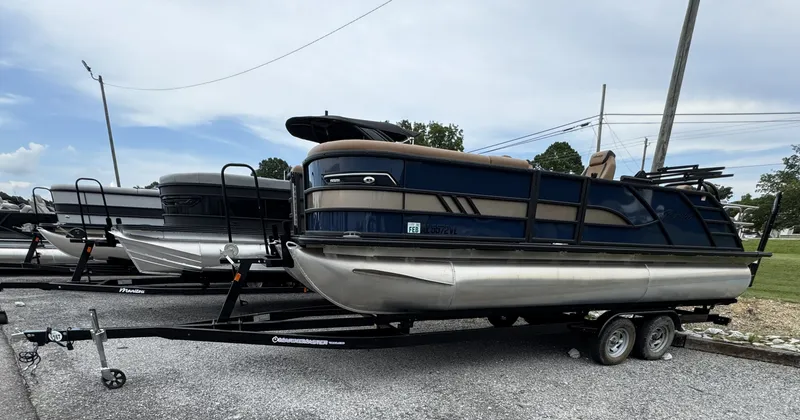 Slide: The Image of A 2026 Bentley Pontoons Elite 223 SwingBack DC on a trailer in a parking area. - 18