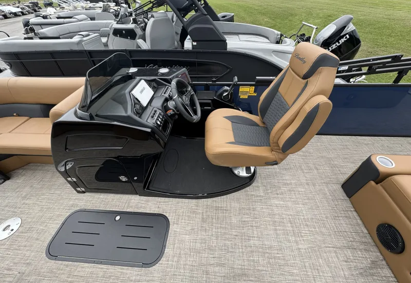 Slide: The Image of The image shows the cockpit of a Bentley Pontoons Elite 223 SwingBack DC with a sleek helm and comfortable seating. - 9