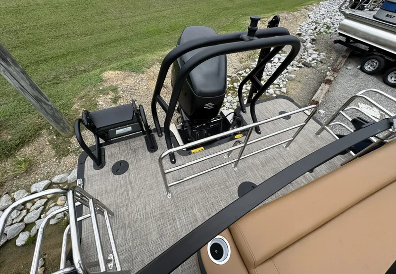Slide: The Image of The image shows the rear of a 2026 Bentley Pontoons Elite 223 SwingBack DC with a Suzuki engine. - 15