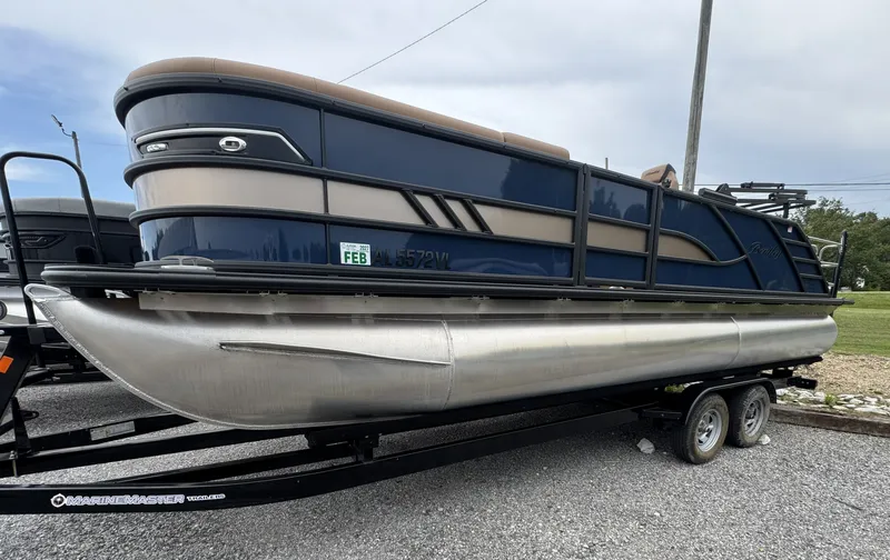 The Image of A 2026 Bentley Pontoons Elite 223 SwingBack DC on a trailer. The boat features sleek blue and silver accents. - 1