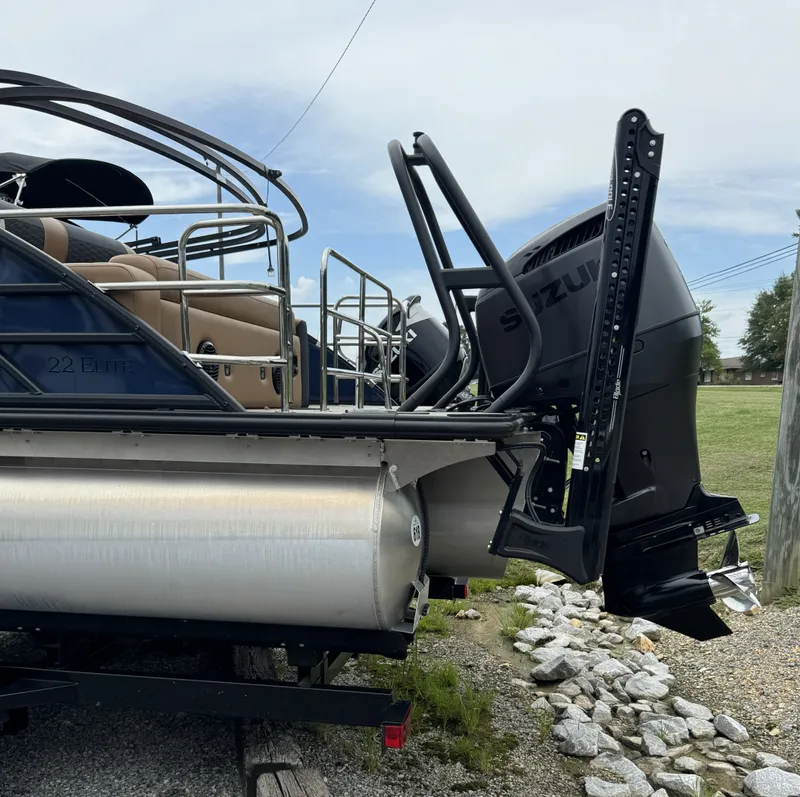 Slide: The Image of The image shows a 2026 Bentley Pontoons Elite 223 SwingBack DC with a Suzuki outboard motor. - 19
