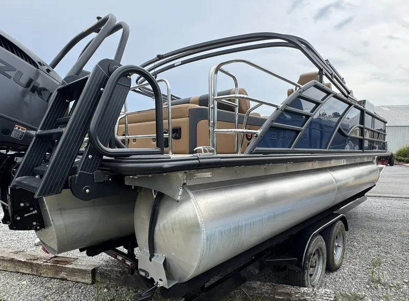 Slide: The Image of A 2026 Bentley Pontoons Elite 223 SwingBack DC on a trailer, featuring sleek seating and sturdy design. - 4