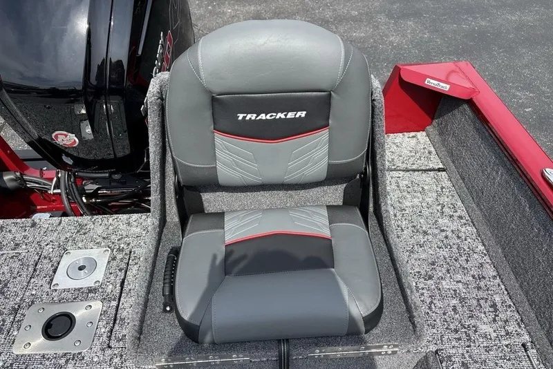 Slide: The Image of 2025 Tracker Pro Guide V-175 Combo boat seat, gray and red design, on textured flooring. - 34