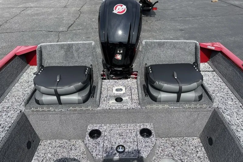 Slide: The Image of 2025 Tracker Pro Guide V-175 Combo boat interior with folded seats and motor. - 44