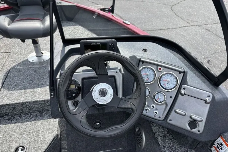 Slide: The Image of 2025 Tracker Pro Guide V-175 Combo boat dashboard with steering wheel and gauges. - 28