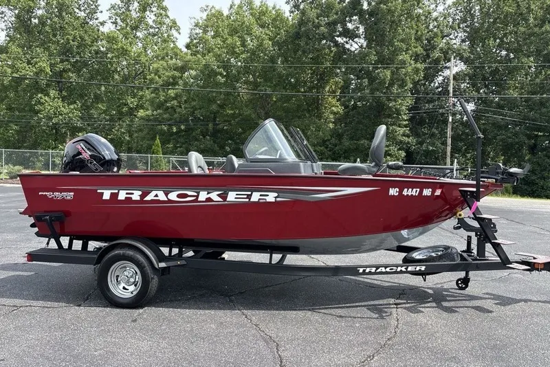 Slide: The Image of 2025 Tracker Pro Guide V-175 Combo boat on trailer, parked outdoors. - 39