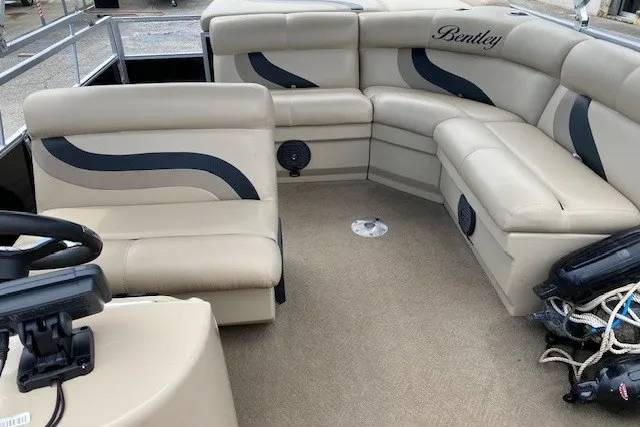 Slide: The Image of Luxurious interior of a 2015 Bentley Pontoons 220 Cruise with beige seating. - 8