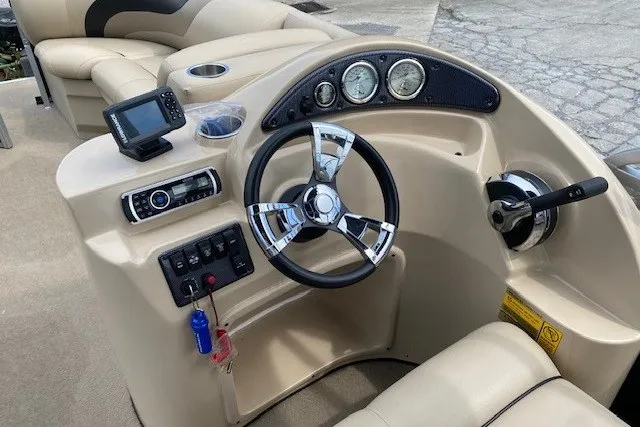 Slide: The Image of 2015 Bentley Pontoons 220 Cruise dashboard with steering wheel, controls, and navigation system. - 4