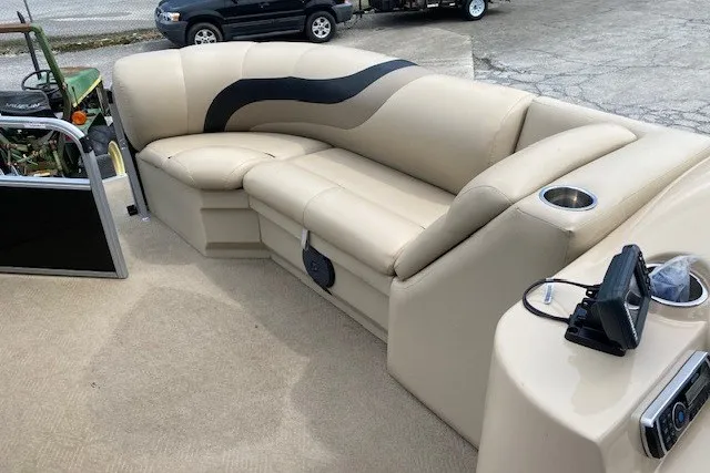 Slide: The Image of Luxurious seating on a 2015 Bentley Pontoons 220 Cruise boat, featuring beige upholstery. - 6