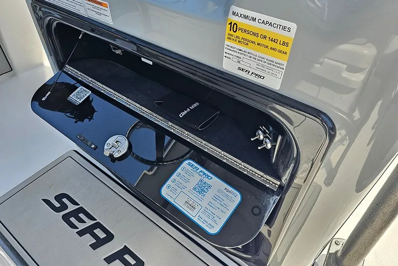 Slide: The Image of 2026 Sea Pro 250 Bay boat compartment with capacity label and QR code. - 25