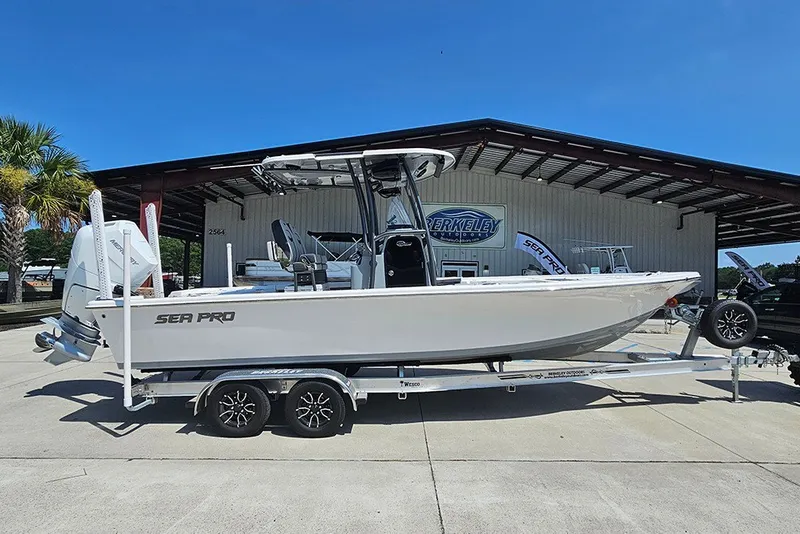The Image of 2026 Sea Pro 250 Bay boat on trailer at dealership, side view. - 1