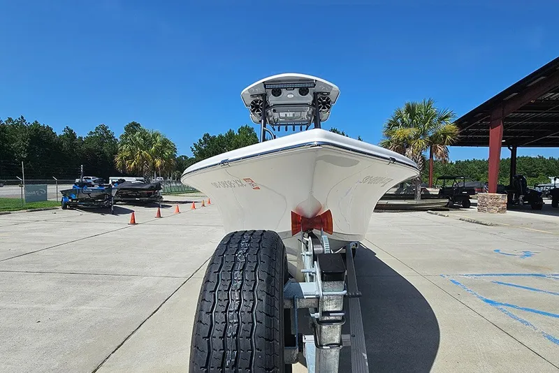 Slide: The Image of 2026 Sea Pro 250 Bay boat on trailer, parked outdoors under clear blue sky. - 5