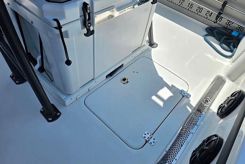 Slide: The Image of 2026 Sea Pro 250 Bay boat deck with storage hatch and cooler. - 17