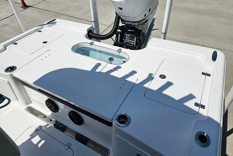 Slide: The Image of 2026 Sea Pro 250 Bay boat deck with motor and storage compartments. - 12