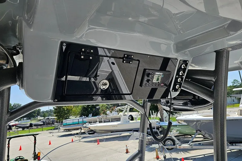Slide: The Image of 2026 Sea Pro 250 Bay boat console with electronics and storage compartments. - 23