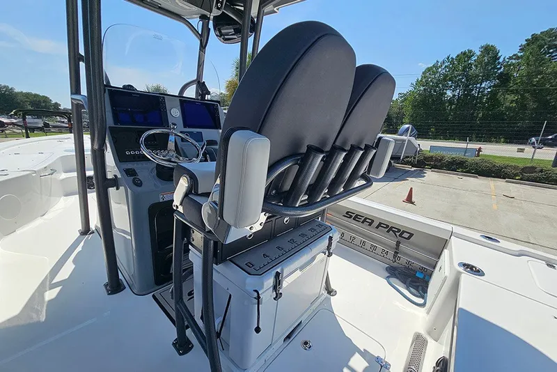 Slide: The Image of 2026 Sea Pro 250 Bay boat interior with helm and seating area. - 19