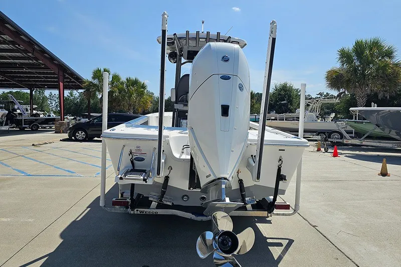 Slide: The Image of 2026 Sea Pro 250 Bay boat with powerful outboard motor, parked in a sunny marina. - 9