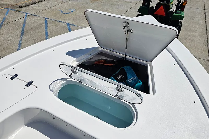 Slide: The Image of 2026 Sea Pro 250 Bay boat with open storage compartments on deck. - 31