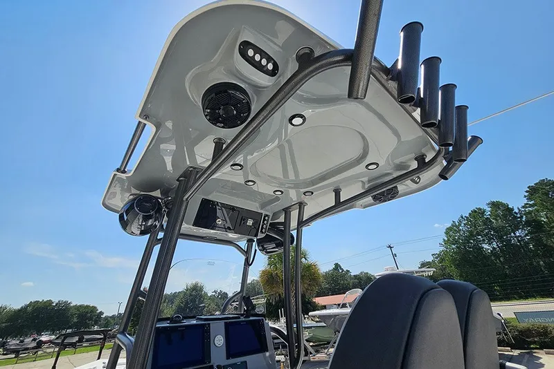 Slide: The Image of 2026 Sea Pro 250 Bay boat's T-top with rod holders and speakers under clear sky. - 21