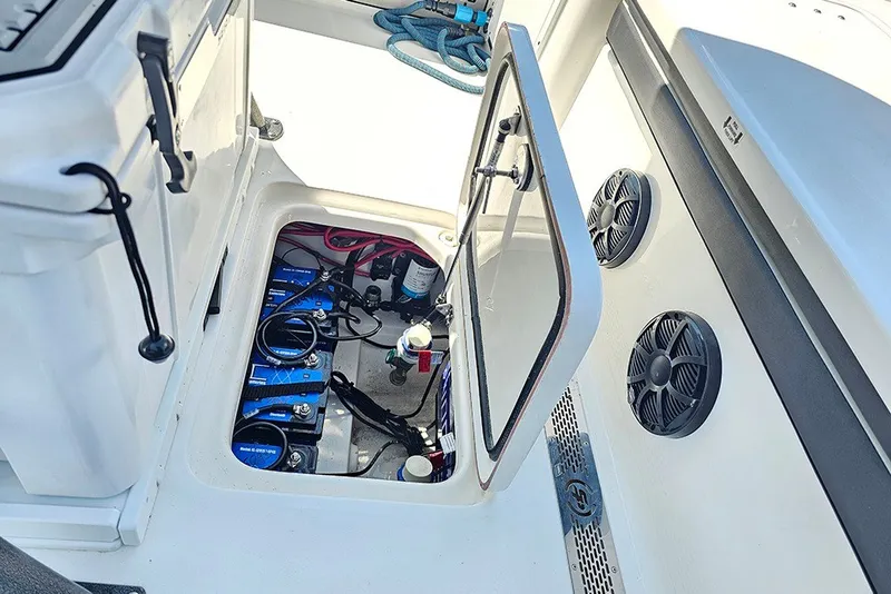 Slide: The Image of Open hatch on 2026 Sea Pro 250 Bay boat showing battery compartment and wiring. - 18
