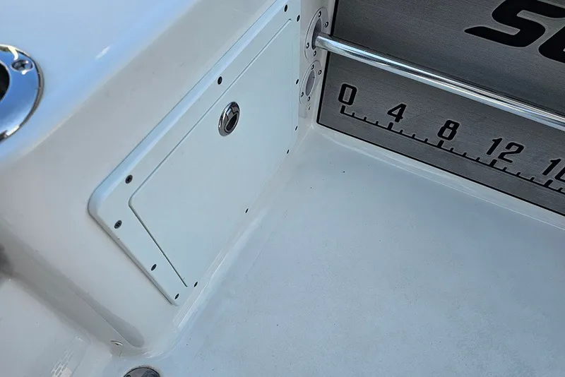 Slide: The Image of 2026 Sea Pro 250 Bay boat interior with storage compartment and measurement scale. - 15