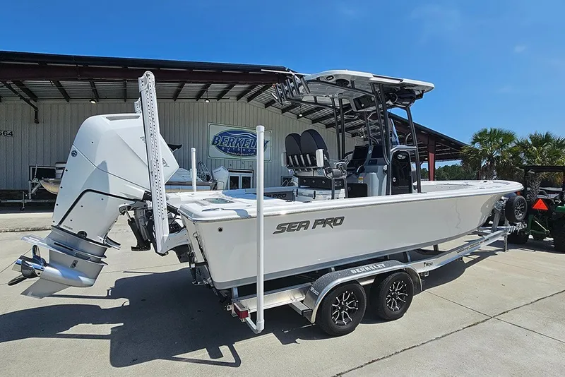 Slide: The Image of 2026 Sea Pro 250 Bay boat on trailer, parked outdoors under clear blue sky. - 3