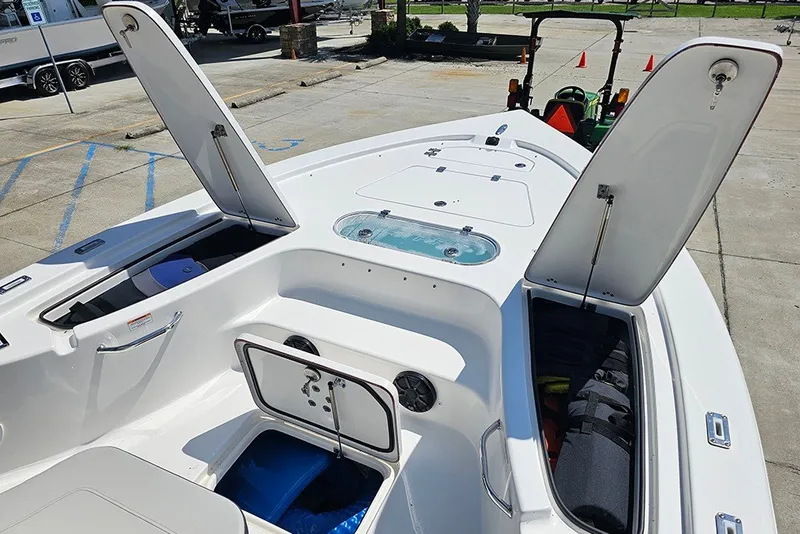 Slide: The Image of 2026 Sea Pro 250 Bay boat with open storage compartments and sleek design. - 32