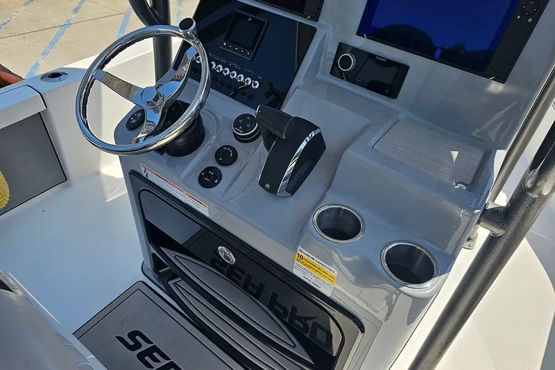 Slide: The Image of 2026 Sea Pro 250 Bay boat console with steering wheel and controls. - 24