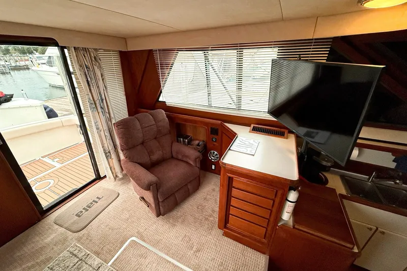 Slide: The Image of Interior of 1989 Tiara Yachts 3600 Convertible with recliner and TV, dock view. - 31