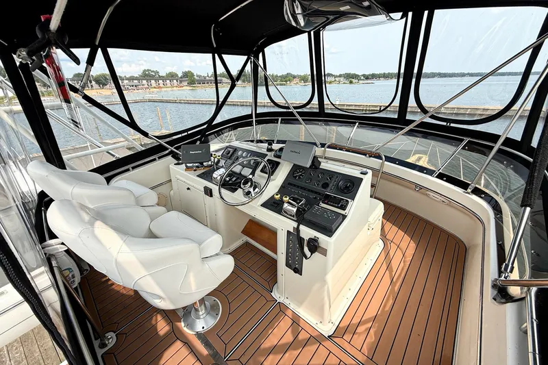 Slide: The Image of 1989 Tiara Yachts 3600 Convertible helm with modern controls and panoramic water views. - 14