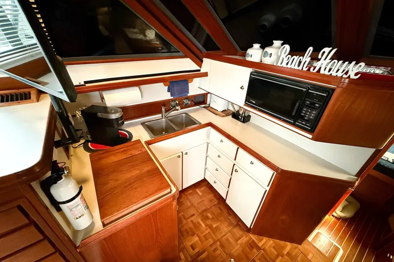 Slide: The Image of 1989 Tiara Yachts 3600 Convertible kitchen with wood cabinetry and modern appliances. - 33