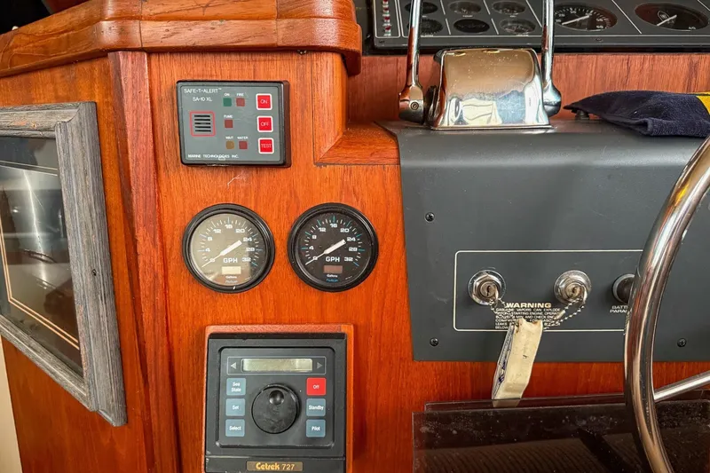 Slide: The Image of Control panel of a 1989 Tiara Yachts 3600 Convertible with gauges and switches. - 26