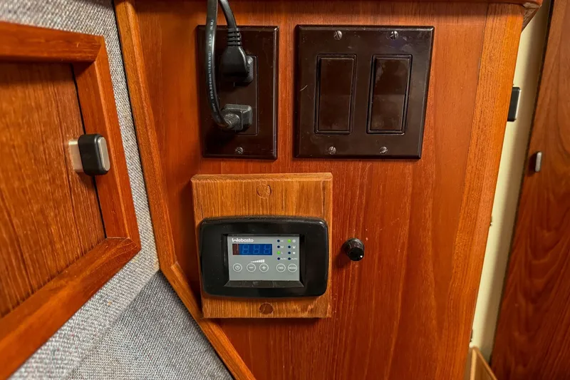 Slide: The Image of Control panel on 1989 Tiara Yachts 3600 Convertible, featuring wood finish and electronic display. - 46