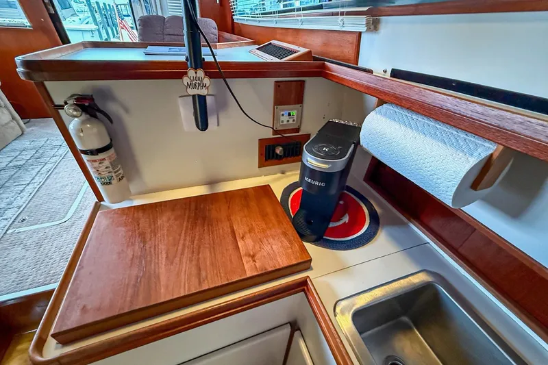Slide: The Image of 1989 Tiara Yachts 3600 Convertible kitchen area with Keurig, sink, and wooden countertop. - 34