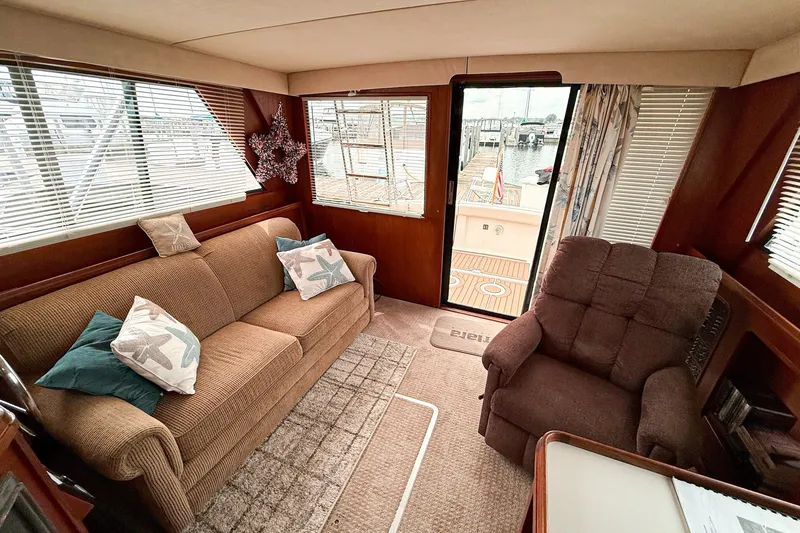 Slide: The Image of Interior of 1989 Tiara Yachts 3600 Convertible with cozy seating and nautical decor. - 30
