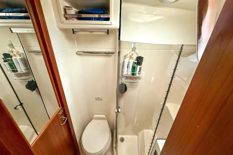 Slide: The Image of Bathroom interior of 1989 Tiara Yachts 3600 Convertible, featuring toilet and shower amenities. - 41