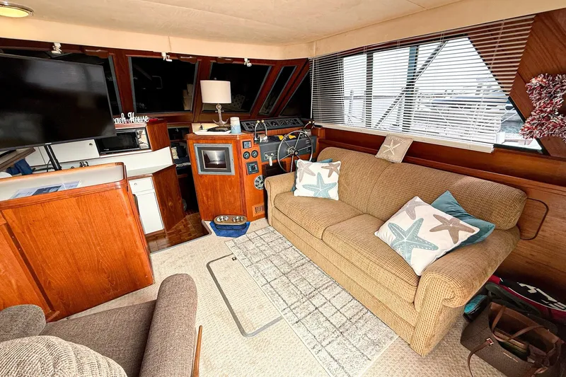 Slide: The Image of Interior of 1989 Tiara Yachts 3600 Convertible with cozy seating and nautical decor. - 29