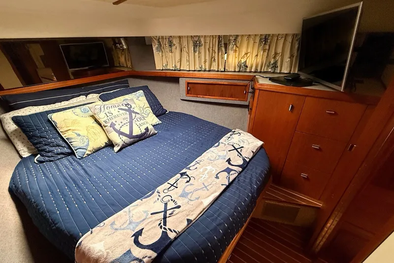 Slide: The Image of Cozy bedroom in 1989 Tiara Yachts 3600 Convertible with nautical-themed decor. - 44